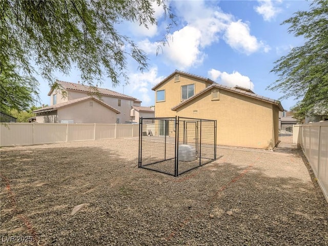 7375 Emerald Glow St, Las Vegas, NV 89123 - rear view of property with stucco siding, a fenced backyard, and a tile roof