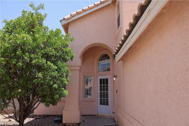 6492 Silent Pine Ave, Las Vegas, NV 89156 - doorway to property with stucco siding and a tiled roof
