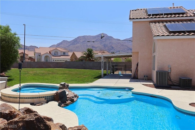 6492 Silent Pine Ave, Las Vegas, NV 89156 - view of swimming pool with a mountain view, a fenced backyard, a patio, and a pool with connected hot tub