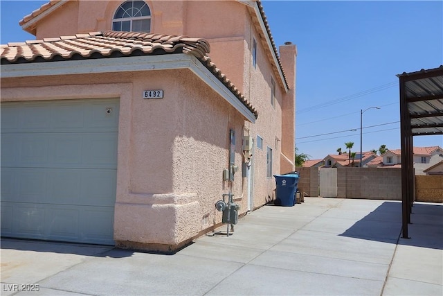 6492 Silent Pine Ave, Las Vegas, NV 89156 - view of property exterior featuring stucco siding and a tile roof