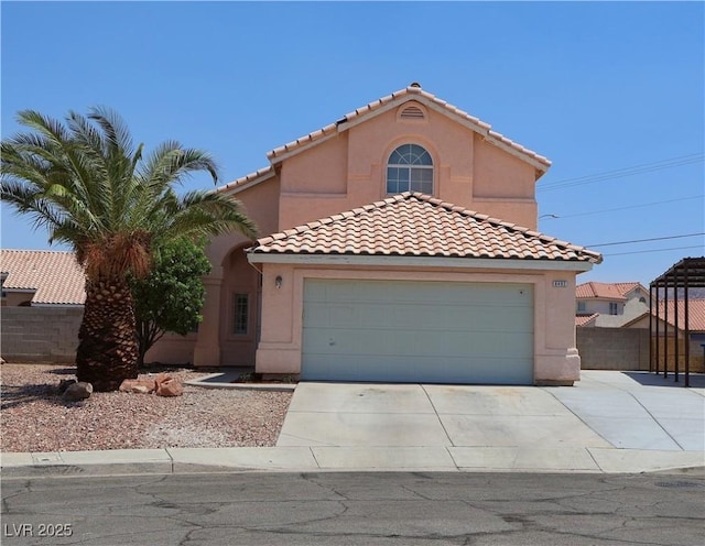 6492 Silent Pine Ave, Las Vegas, NV 89156 - mediterranean / spanish-style home featuring stucco siding, a tiled roof, concrete driveway, and a garage