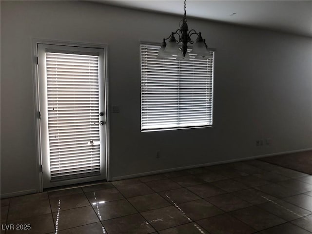 714 Calamus Palm Pl, Henderson, NV 89011 - unfurnished dining area with a chandelier and dark tile patterned floors