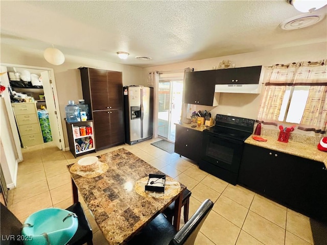 4109 Studio St, Las Vegas, NV 89115 - kitchen featuring black / electric stove, stainless steel refrigerator with ice dispenser, under cabinet range hood, light tile patterned floors, and a textured ceiling