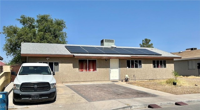 4109 Studio St, Las Vegas, NV 89115 - ranch-style house featuring solar panels, stucco siding, and a chimney