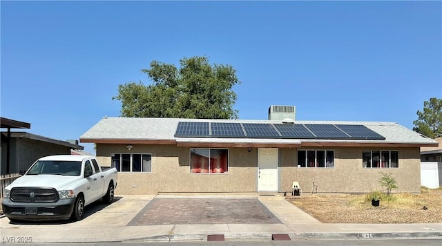 4109 Studio St, Las Vegas, NV 89115 - single story home with solar panels, stucco siding, and a chimney