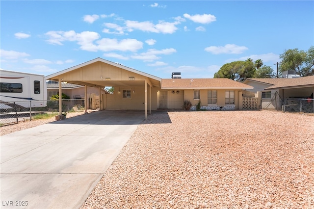 4436 E Ogden Ave, Las Vegas, NV 89110 - view of front of home with driveway, an attached carport, and stucco siding