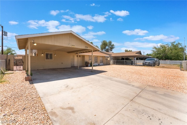 4436 E Ogden Ave, Las Vegas, NV 89110 - view of front facade featuring driveway, a gate, and a carport