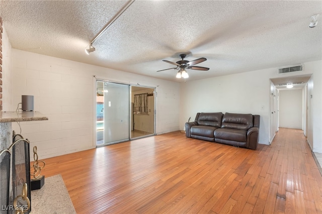 4436 E Ogden Ave, Las Vegas, NV 89110 - living room featuring ceiling fan, light wood finished floors, and a textured ceiling