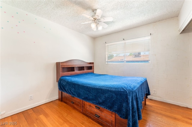 4436 E Ogden Ave, Las Vegas, NV 89110 - bedroom with light wood finished floors, a textured ceiling, and ceiling fan