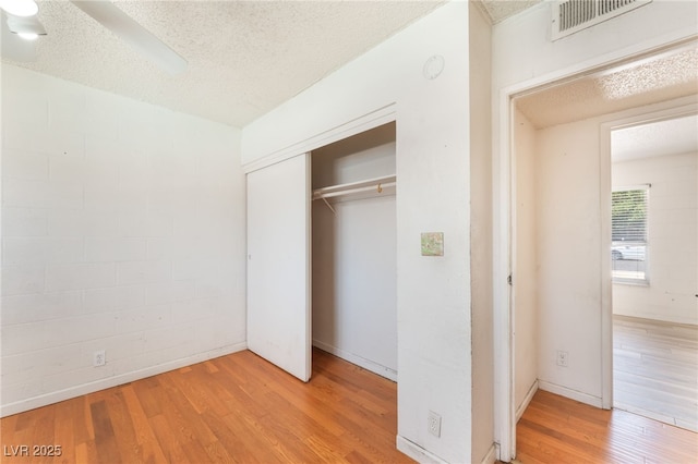 4436 E Ogden Ave, Las Vegas, NV 89110 - unfurnished bedroom with wood finished floors, a textured ceiling, a closet, and ceiling fan