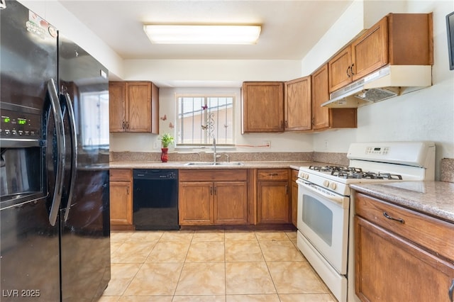 4436 E Ogden Ave, Las Vegas, NV 89110 - kitchen featuring black appliances, under cabinet range hood, brown cabinets, and light countertops