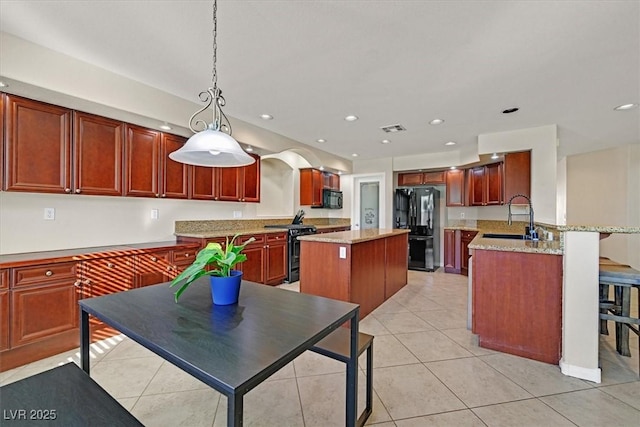 609 Doubleshot Ln, Henderson, NV 89052 - kitchen featuring black appliances, a center island, light tile patterned floors, a peninsula, and recessed lighting