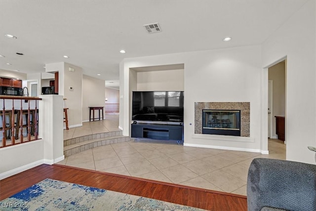 609 Doubleshot Ln, Henderson, NV 89052 - living room featuring light tile patterned floors, a glass covered fireplace, and recessed lighting