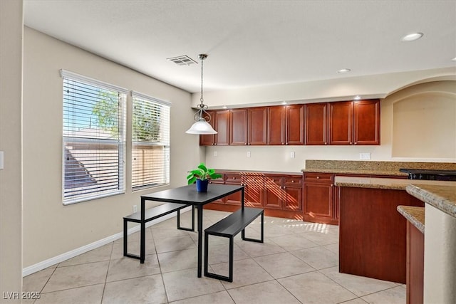 609 Doubleshot Ln, Henderson, NV 89052 - kitchen featuring hanging light fixtures, light tile patterned floors, arched walkways, recessed lighting, and reddish brown cabinets