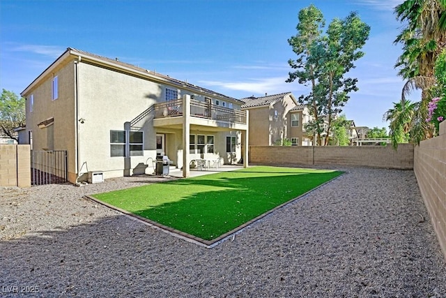 609 Doubleshot Ln, Henderson, NV 89052 - rear view of property featuring a balcony, a fenced backyard, a patio, and stucco siding