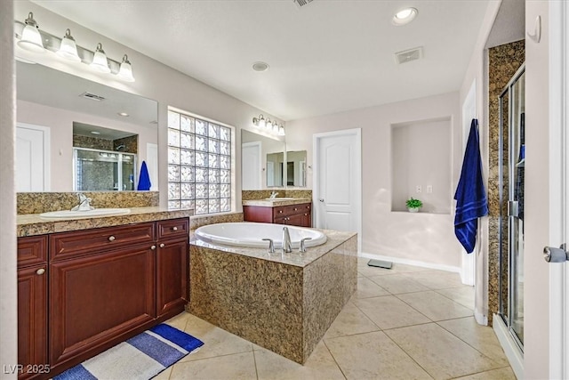609 Doubleshot Ln, Henderson, NV 89052 - bathroom with a shower stall, two vanities, a garden tub, and tile patterned floors