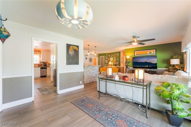 908 Bonita Ave, Las Vegas, NV 89104 - living area featuring light wood finished floors, a chandelier, and ceiling fan