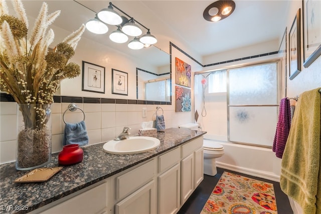 908 Bonita Ave, Las Vegas, NV 89104 - bathroom with vanity, bath / shower combo with glass door, and tasteful backsplash