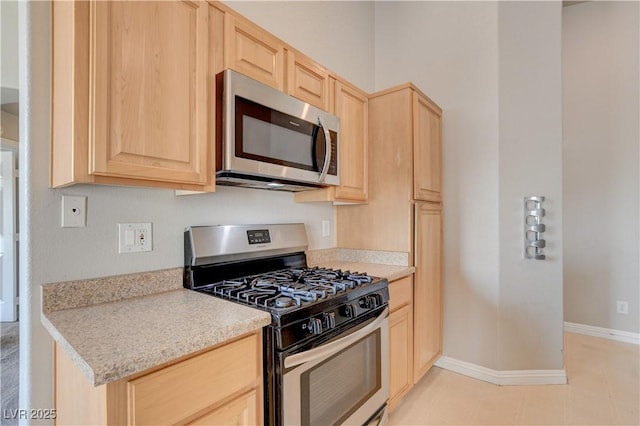3617 Indigo Flower St Unit 1, North Las Vegas, NV 89084 - kitchen featuring stainless steel appliances, light brown cabinets, and light countertops