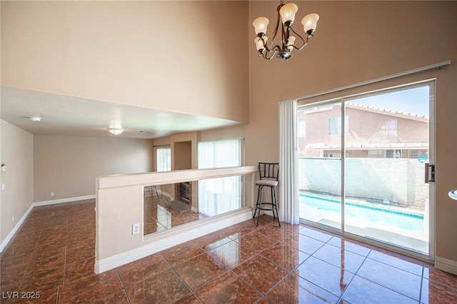 8708 Western Saddle Ave, Las Vegas, NV 89129 - empty room with a chandelier and a high ceiling