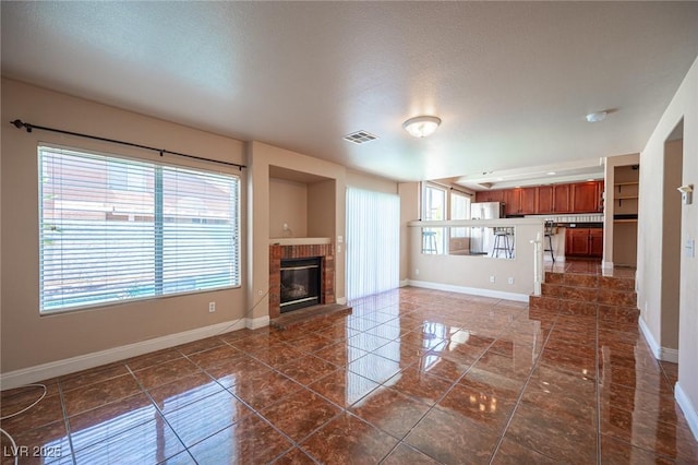 8708 Western Saddle Ave, Las Vegas, NV 89129 - unfurnished living room featuring a fireplace, dark tile patterned floors, and a textured ceiling