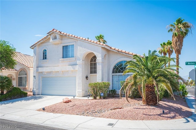 8708 Western Saddle Ave, Las Vegas, NV 89129 - mediterranean / spanish house with stucco siding, driveway, a tiled roof, and a garage