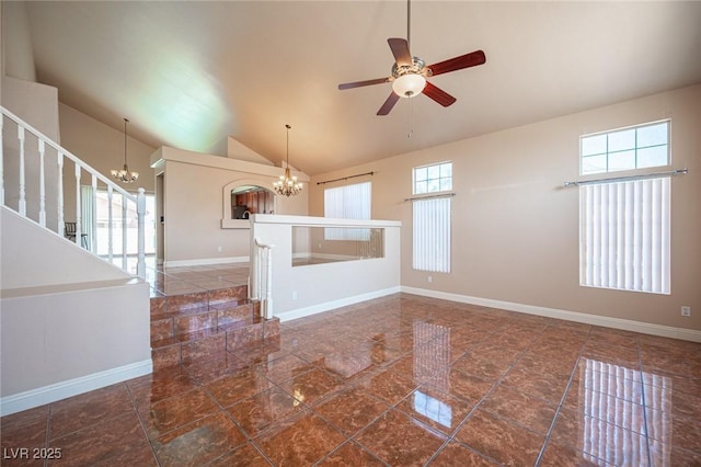 8708 Western Saddle Ave, Las Vegas, NV 89129 - unfurnished living room featuring a chandelier, vaulted ceiling, stairway, and ceiling fan