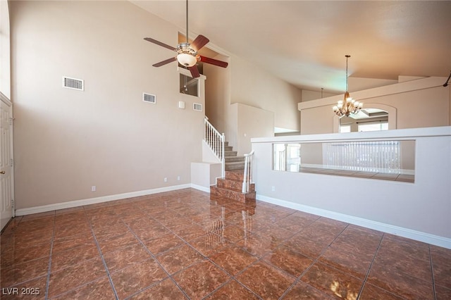 8708 Western Saddle Ave, Las Vegas, NV 89129 - unfurnished living room with high vaulted ceiling, a chandelier, ceiling fan, and stairs