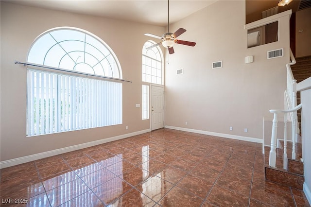 8708 Western Saddle Ave, Las Vegas, NV 89129 - spare room featuring a ceiling fan, a high ceiling, and stairway