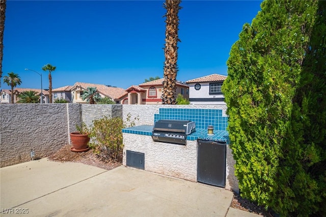 8708 Western Saddle Ave, Las Vegas, NV 89129 - view of patio with area for grilling and a residential view