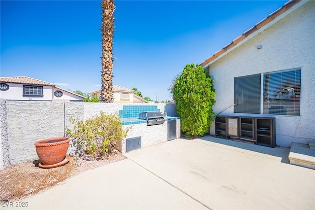 8708 Western Saddle Ave, Las Vegas, NV 89129 - fenced backyard featuring area for grilling and a patio area