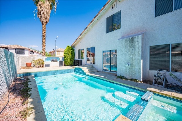 8708 Western Saddle Ave, Las Vegas, NV 89129 - view of swimming pool with a patio area, a fenced backyard, and a pool with connected hot tub