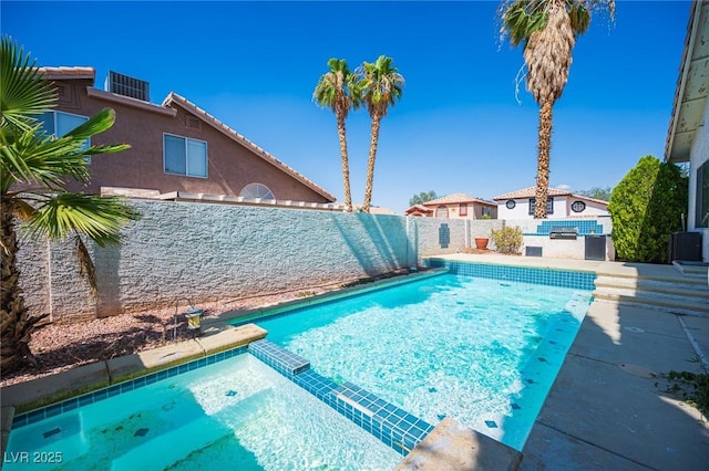 8708 Western Saddle Ave, Las Vegas, NV 89129 - view of swimming pool featuring a pool with connected hot tub, a fenced backyard, and a patio