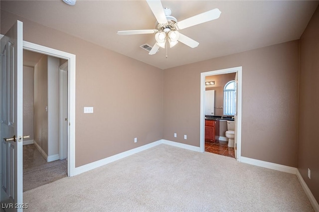 8708 Western Saddle Ave, Las Vegas, NV 89129 - unfurnished bedroom featuring light carpet, ensuite bath, and ceiling fan