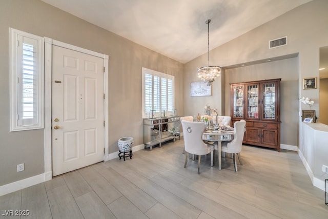 1131 Magic Meadow St, Henderson, NV 89052 - dining room featuring a chandelier, vaulted ceiling, and light wood finished floors