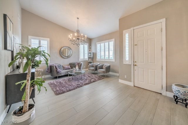 1131 Magic Meadow St, Henderson, NV 89052 - entryway with lofted ceiling, a chandelier, and light wood finished floors