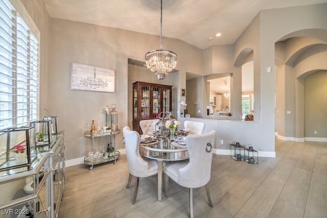 1131 Magic Meadow St, Henderson, NV 89052 - dining room with healthy amount of natural light, a chandelier, light wood-style flooring, and lofted ceiling
