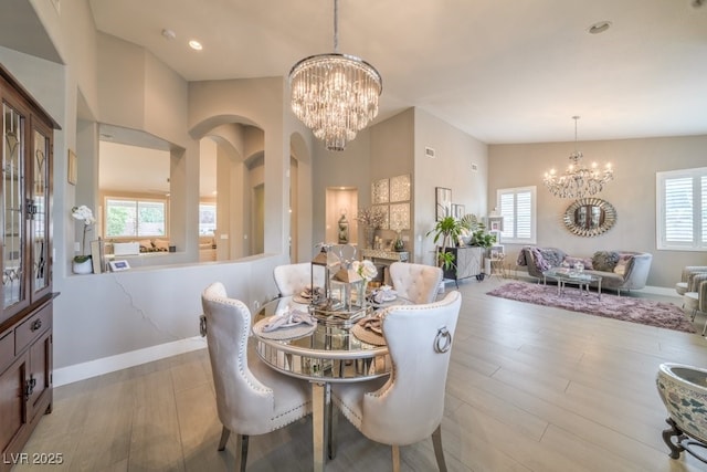 1131 Magic Meadow St, Henderson, NV 89052 - dining space featuring a chandelier, plenty of natural light, and light wood-style flooring