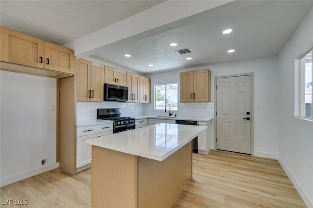 148 Fir St, Henderson, NV 89015 - kitchen with stainless steel range with gas stovetop, dishwasher, light wood-style floors, light countertops, and recessed lighting