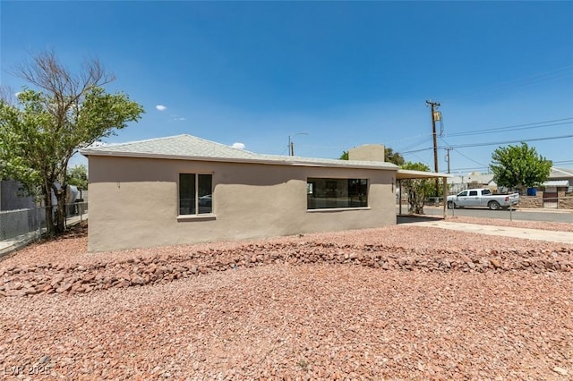 148 Fir St, Henderson, NV 89015 - view of property exterior with stucco siding, driveway, and an attached carport
