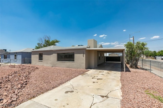 148 Fir St, Henderson, NV 89015 - view of front of house featuring driveway, stucco siding, a carport, and a chimney