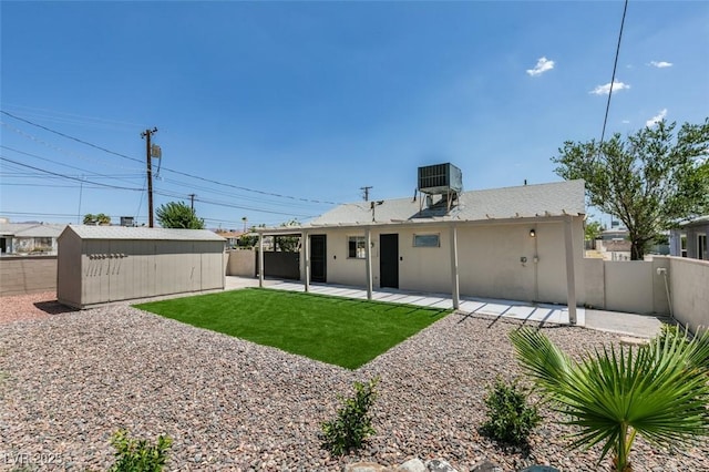 148 Fir St, Henderson, NV 89015 - rear view of property with a fenced backyard, an outdoor structure, and a patio