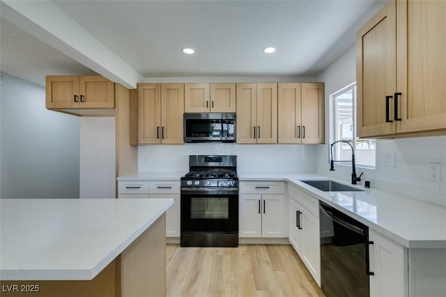 148 Fir St, Henderson, NV 89015 - kitchen with black dishwasher, stainless steel microwave, range with gas stovetop, tasteful backsplash, and light wood finished floors