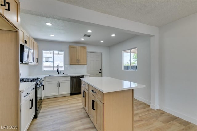 148 Fir St, Henderson, NV 89015 - kitchen with black appliances, light wood-type flooring, plenty of natural light, light countertops, and recessed lighting