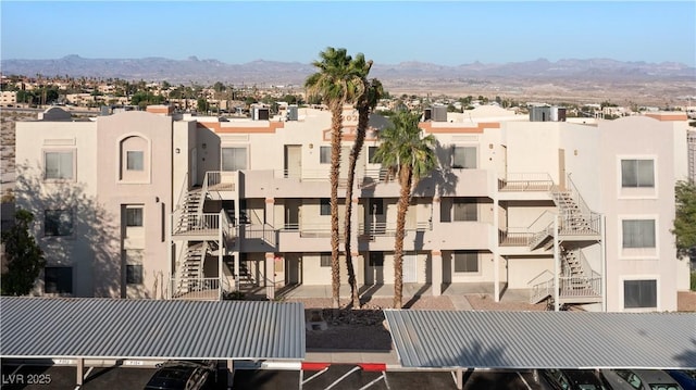 2028 Mesquite Ln Unit 302, Laughlin, NV 89029 - view of building exterior with uncovered parking, a mountain view, and a residential view