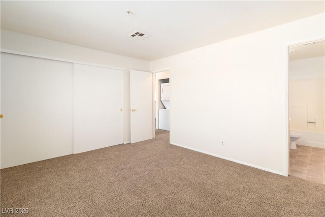 2028 Mesquite Ln Unit 302, Laughlin, NV 89029 - unfurnished bedroom with light colored carpet, a closet, and ensuite bathroom