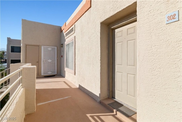 2028 Mesquite Ln Unit 302, Laughlin, NV 89029 - view of exterior entry featuring stucco siding and a balcony