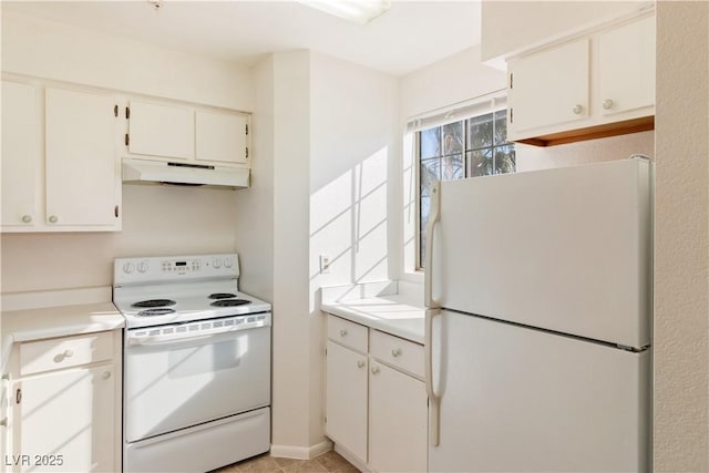 2028 Mesquite Ln Unit 302, Laughlin, NV 89029 - kitchen with white appliances, under cabinet range hood, light countertops, and white cabinets