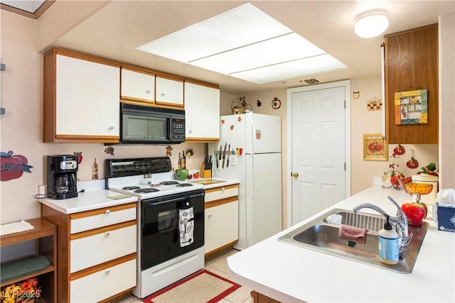 3550 Bay Sands Dr Unit 3096, Laughlin, NV 89029 - kitchen with black microwave, range with electric stovetop, freestanding refrigerator, white cabinets, and light countertops