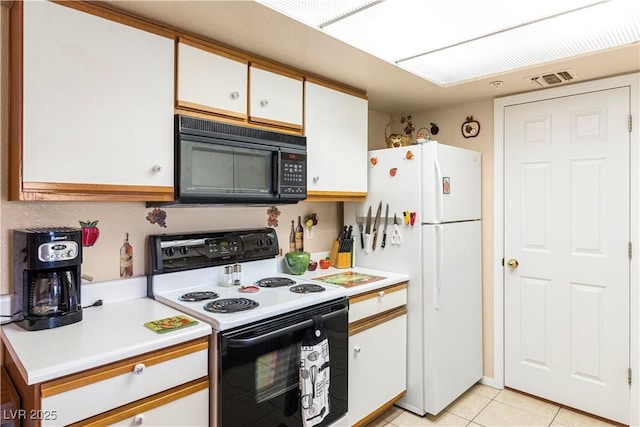 3550 Bay Sands Dr Unit 3096, Laughlin, NV 89029 - kitchen with electric range oven, black microwave, freestanding refrigerator, light countertops, and white cabinetry
